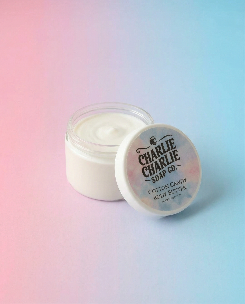 Jar of cotton candy body butter with 'Charlie Charlie Soap Co.' label on a gradient background