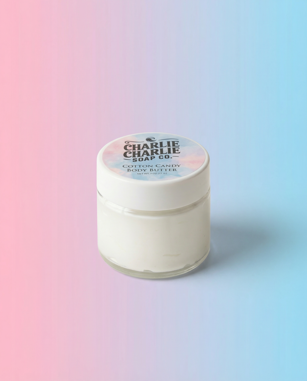 Jar of cotton candy body butter with a gradient background