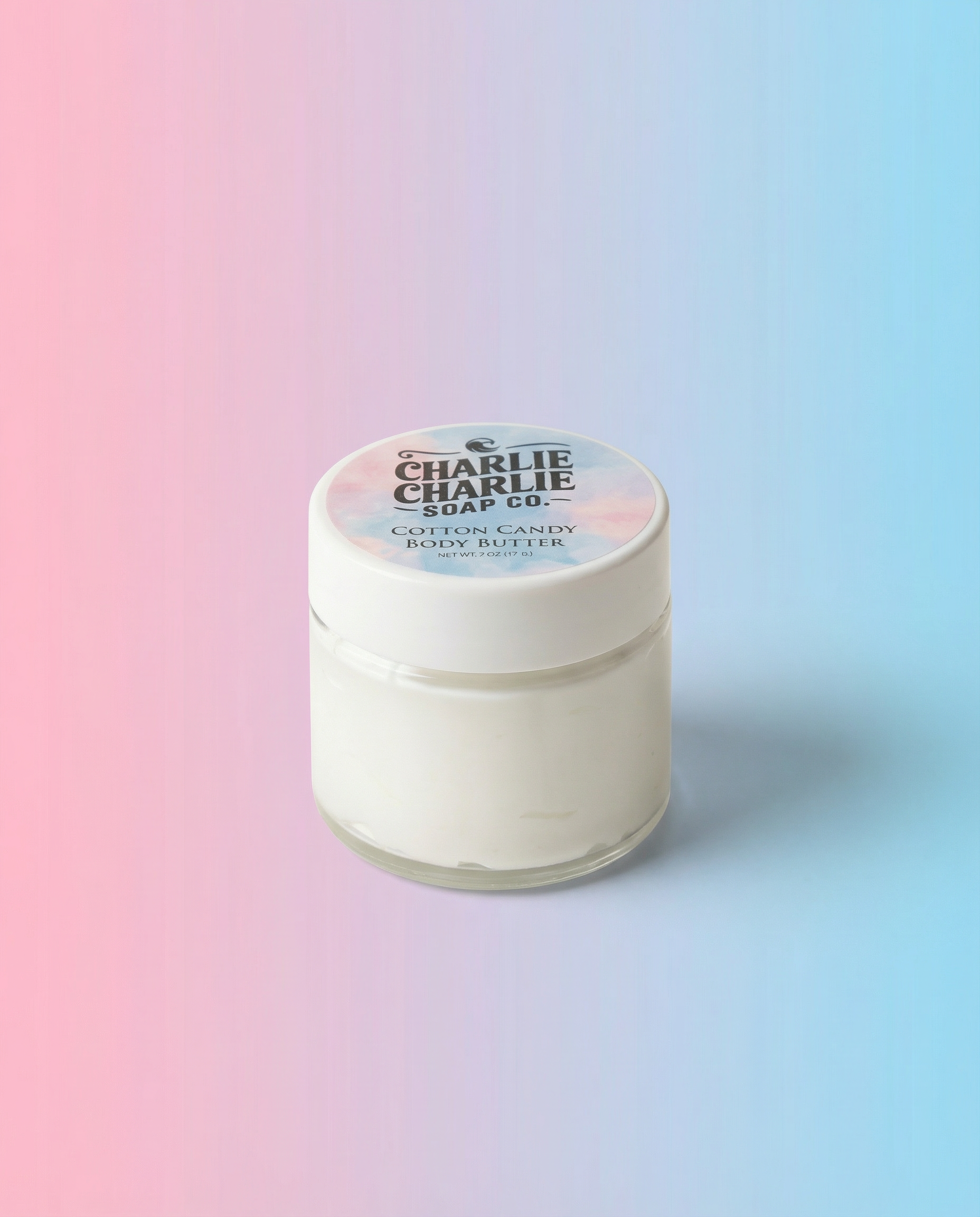 Jar of cotton candy body butter with a gradient background