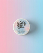 Container of Charlie Charlie Soap Co. Cotton Candy Body Butter on a gradient background
