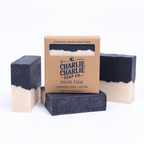 Two layered soap bars with a cardboard box labeled 'Charlie Charlie Soap Co.' on a white background