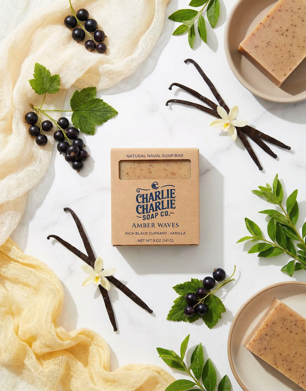 Charlie Charlie Soap Co. amber waves soap bar with vanilla beans, black currants, and leaves on a white background