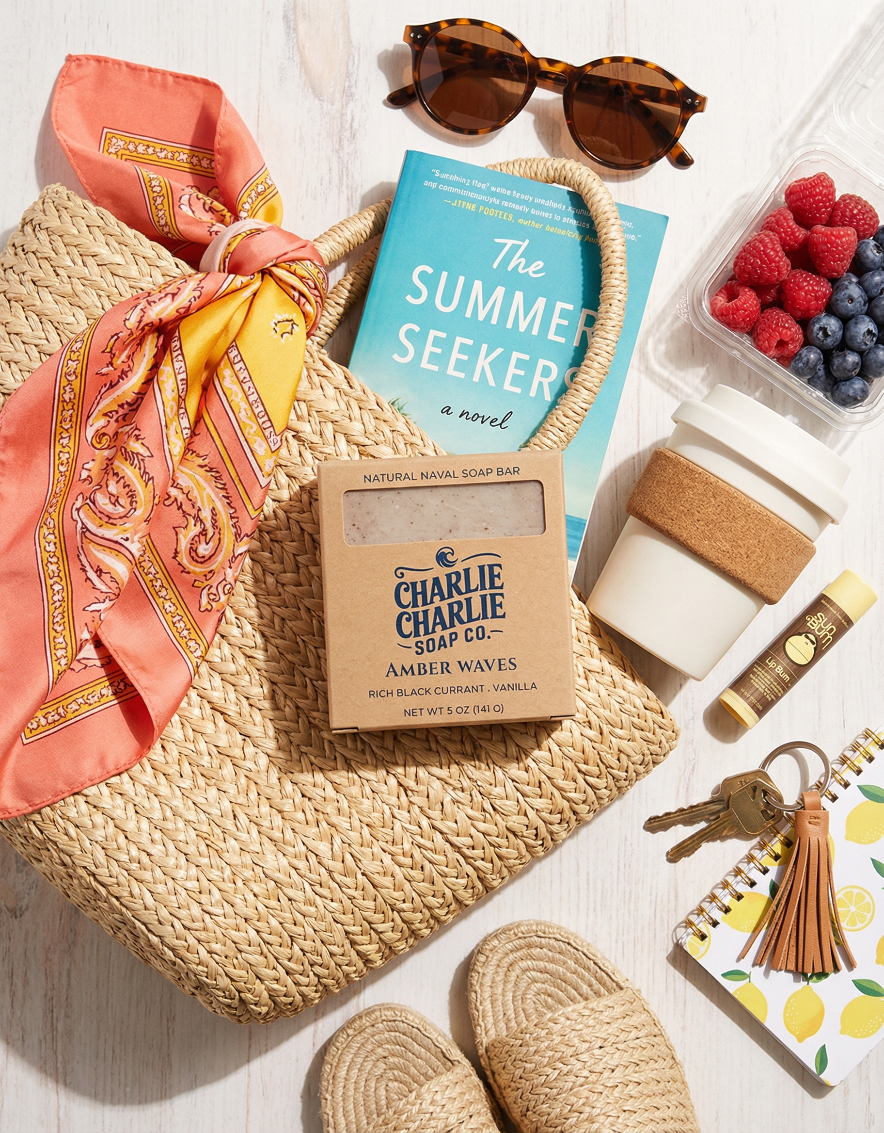 Assorted items including a soap bar, book, sunglasses, and snacks on a wooden surface.