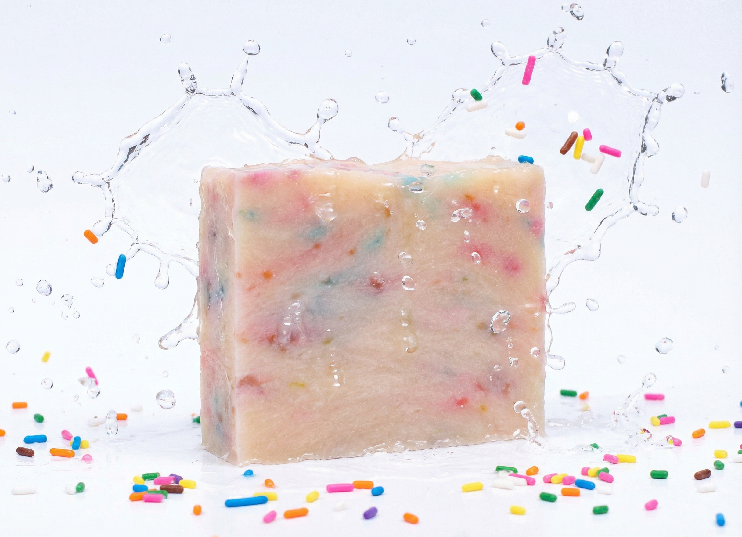 Bar of soap with colorful sprinkles on a white background