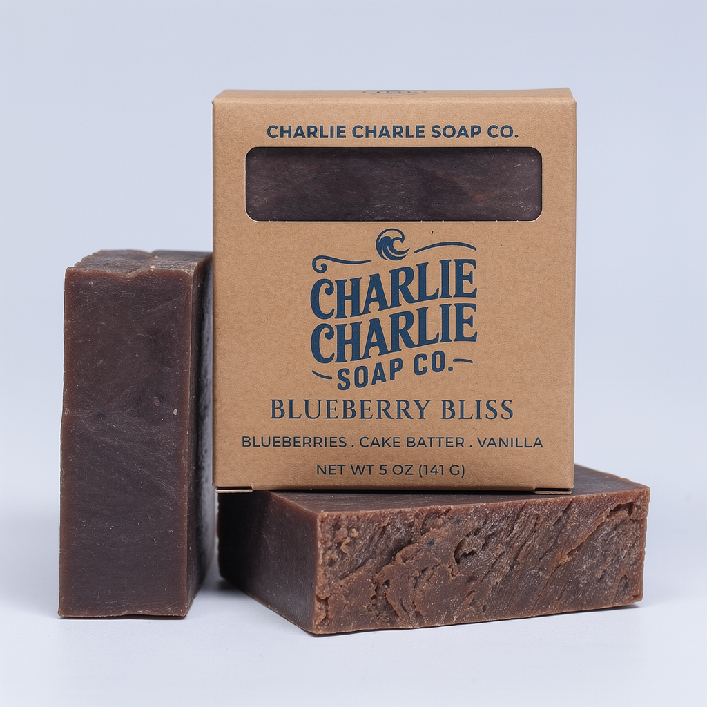 Two bars of soap and their packaging from Charlie Charlie Soap Co. on a light gray background