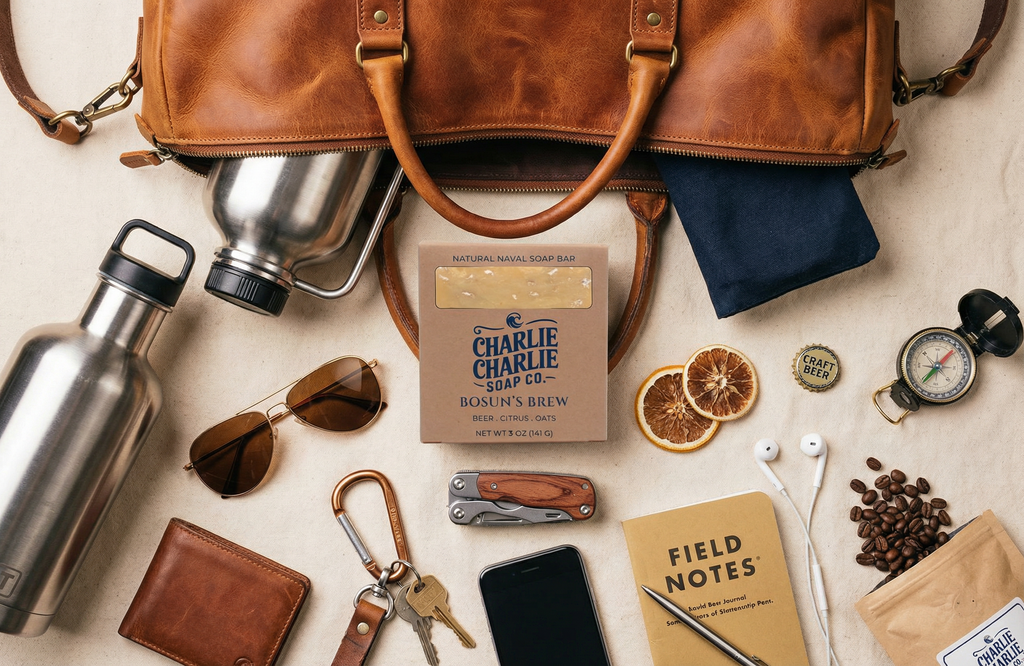 Collection of travel-related items including a leather bag, water bottle, sunglasses, and coffee on a beige surface.
