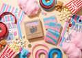 Carnival-themed products including cotton candy, popcorn, and candy canes on a wooden surface.