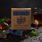 Box of Charlie Charlie Soap Co. soap bar with natural elements on a dark background