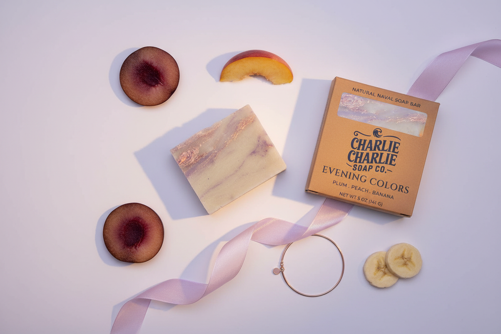 Bar of soap, packaging, and dried fruit on a white background