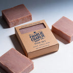 Charlie Charlie Soap Co. pink soap bars with packaging on a light background