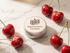 Charlie Charlie Soap Co. sugared cherry lip balm with cherries on a marble surface