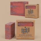 Two natural naval soap bars with 'Charlie Charlie Soap Co.' packaging on a beige background
